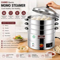 A multi-tier electric steamER cooker with a stainless steel body and black handles, shown with a hand lifting the lid to reveal steaming dumplings. The image includes promotional text, feature icons, and food examples on a wooden table.